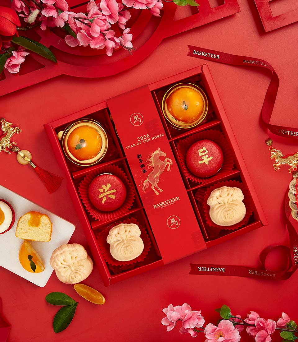 Red and gold luxury dessert gift box with auspicious treats, golden pastries, and money bag cakes for Chinese New Year