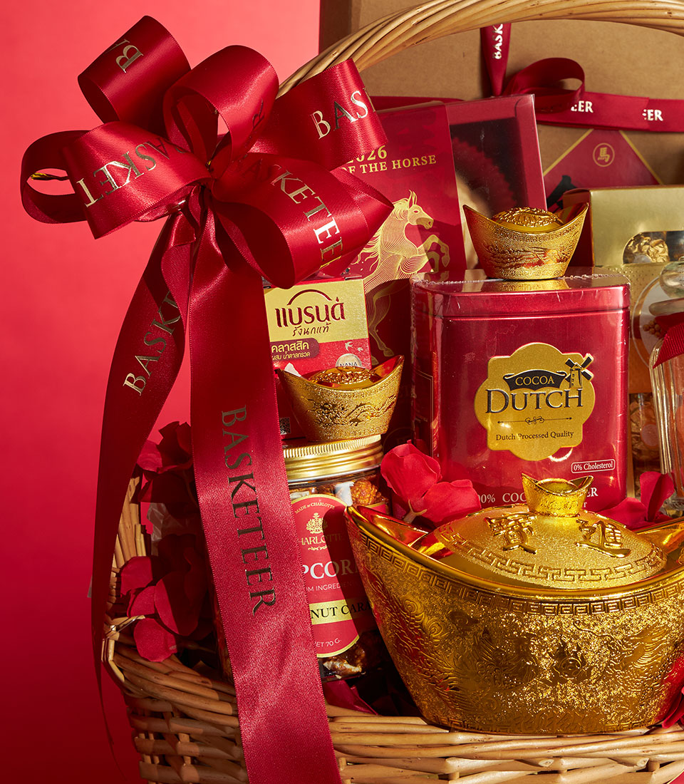 Red and gold wicker gift basket with cocoa, popcorn, and gourmet treats for Chinese New Year celebrations