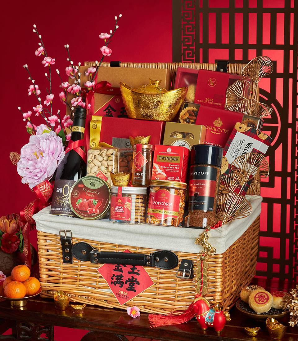 Luxury wicker hamper filled with gourmet treats, non-alcoholic wine, and golden prosperity charms for Chinese New Year