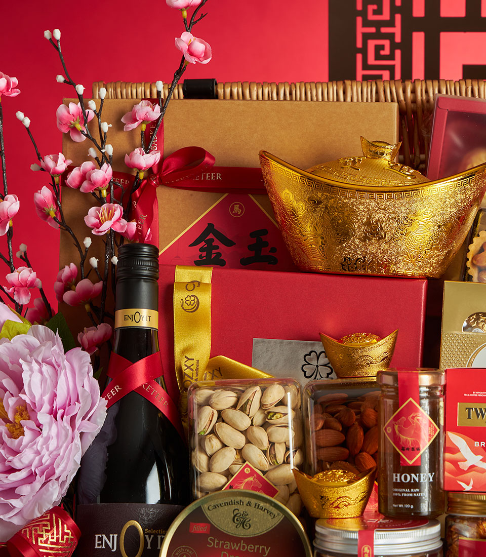 Luxury red and gold gift hamper with non-alcoholic wine, nuts, honey, and festive cherry blossoms for Chinese New Year