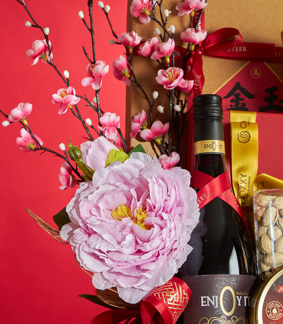 Luxury Chinese New Year gift basket with peony flowers, cherry blossoms, premium non-alcoholic wine, and gourmet treats on