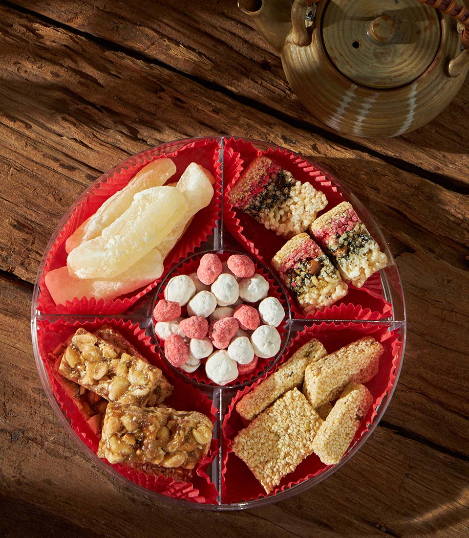 Chinese New Year festive sweets gift tray with candied melon, puffed rice, sesame brittle and sugar candies