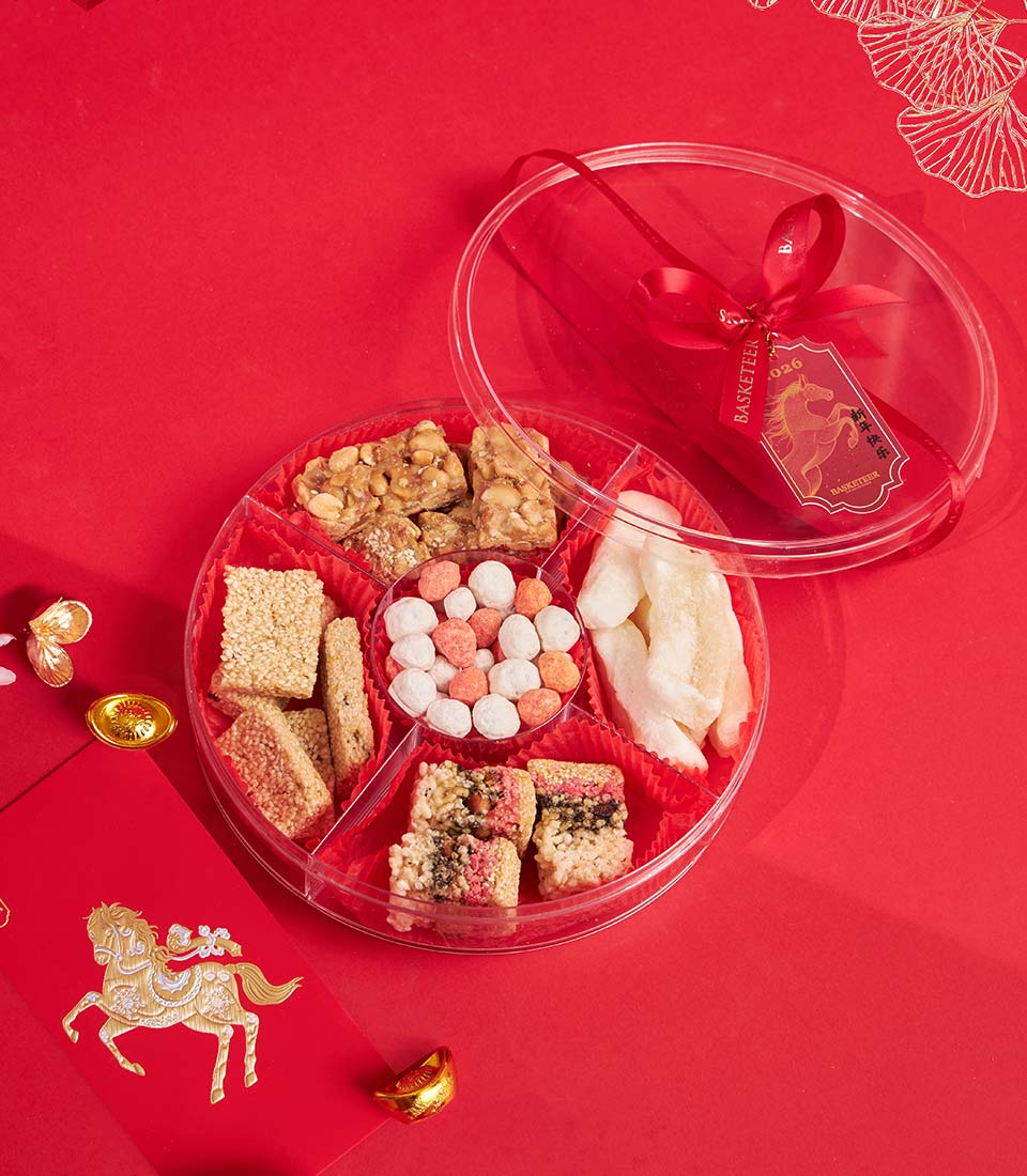Premium Chinese New Year gift box with peanut brittle, sesame bars, and traditional sweets on festive red display