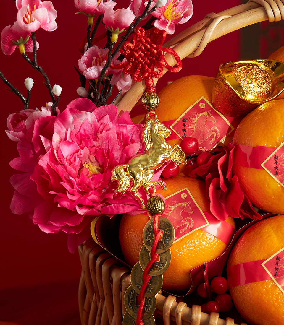 Premium mandarin orange gift basket with festive red bands, pink cherry blossoms, golden horse charm, and lucky coins for