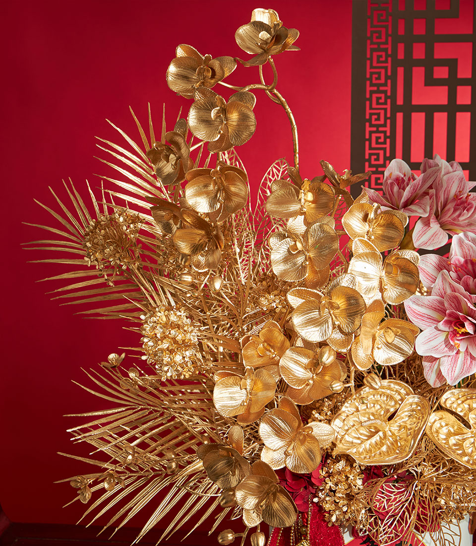 Basketeer premium hamper delivery Thailand: Golden floral arrangement with orchids and palm fronds. Perfect corporate gift Bangkok for Chinese New Year.