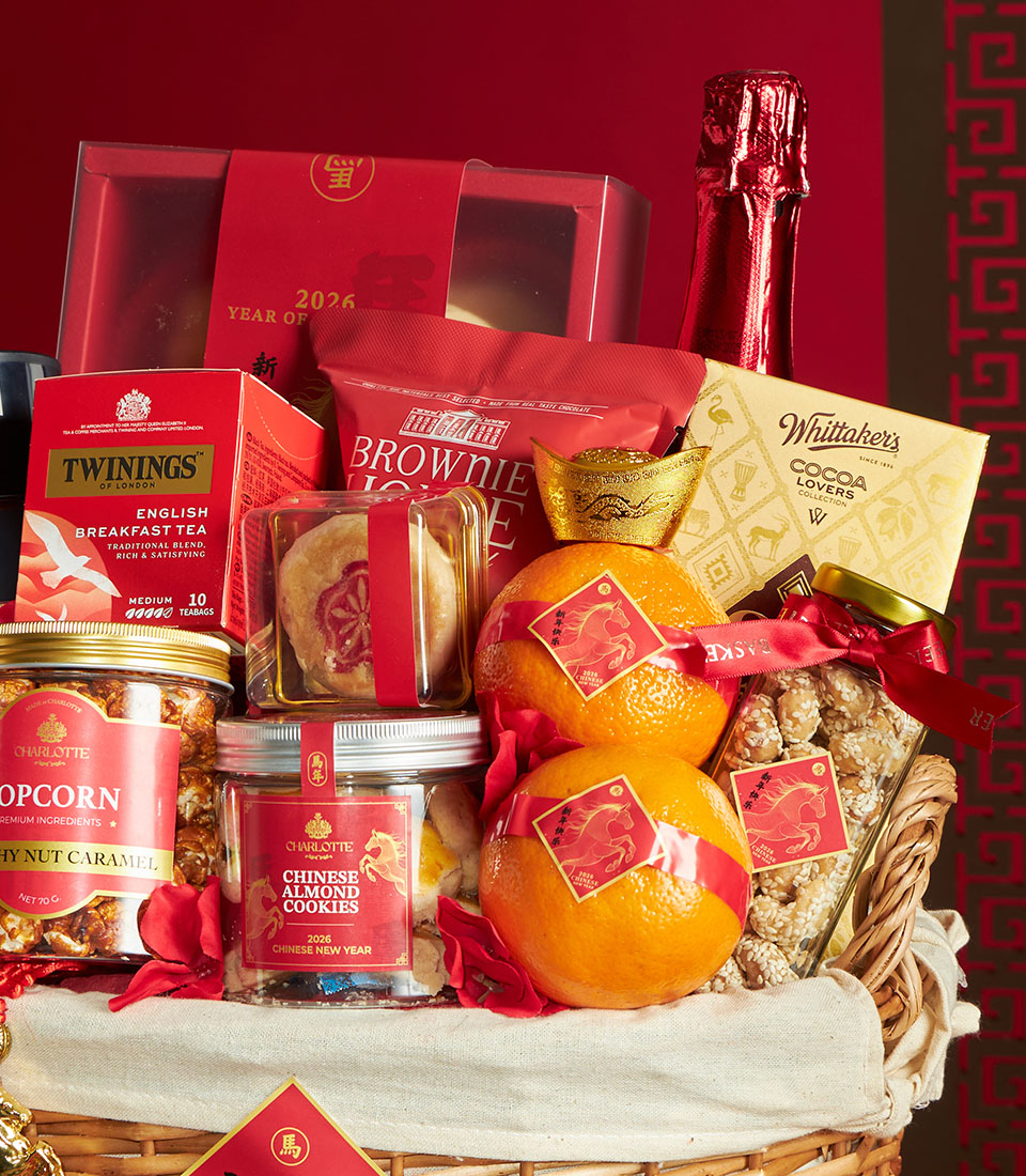 Premium red and gold Chinese New Year gift basket with mandarin oranges, gourmet chocolates, tea, and festive treats