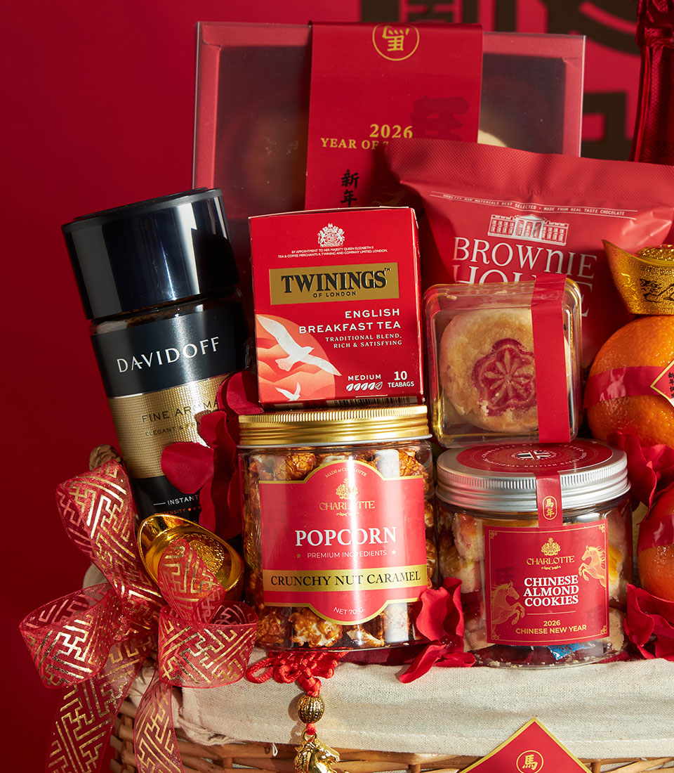 Premium Chinese New Year gift basket with mandarin oranges, gourmet coffee, tea, and artisan treats on festive red background