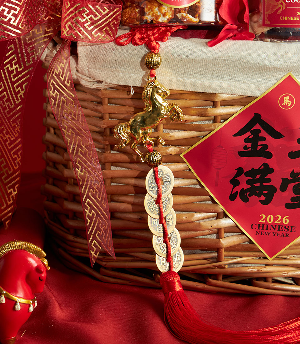 Festive Chinese New Year gift basket with mandarin oranges, woven wicker, red ribbon and gold horse charm