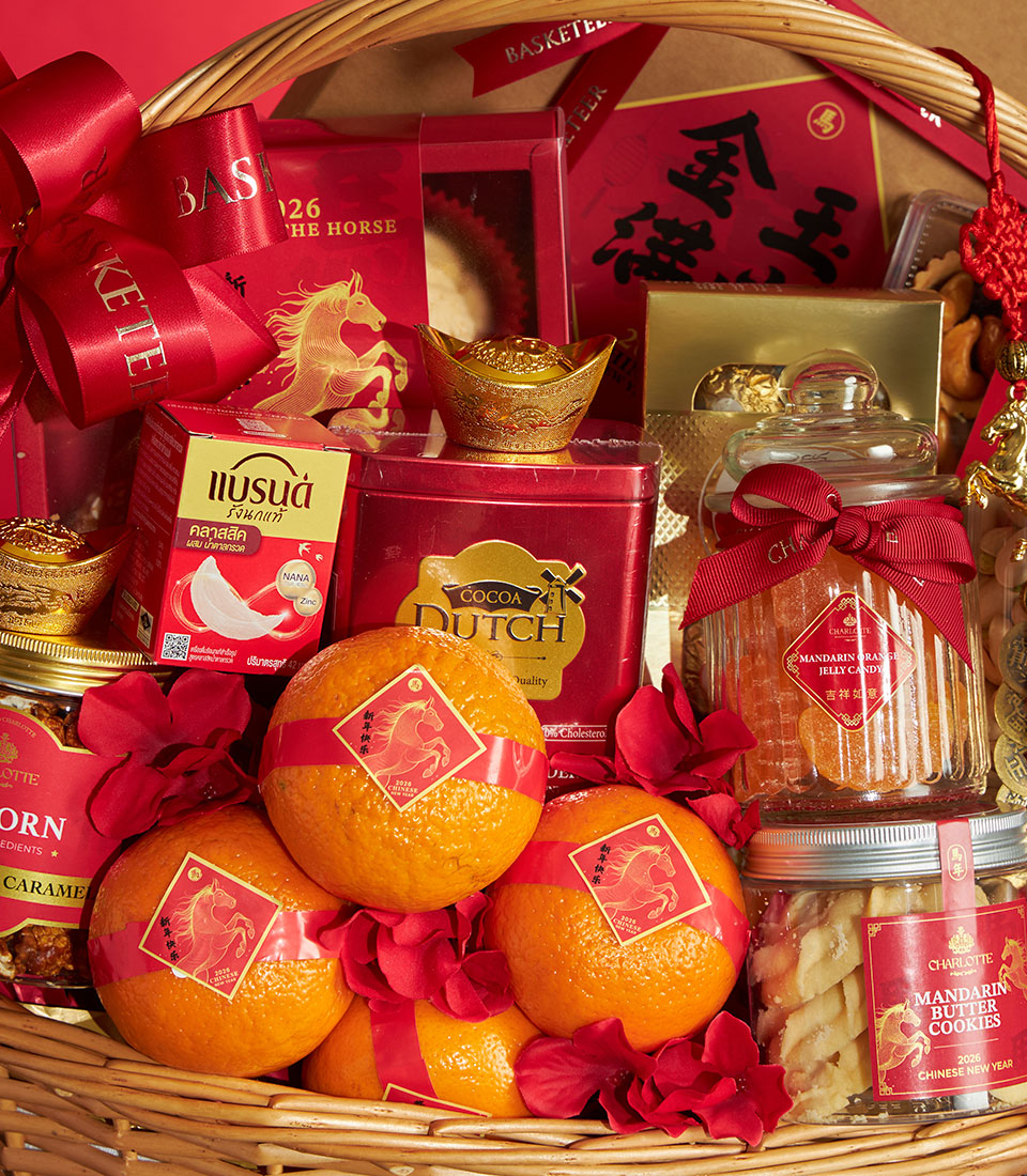 Red and gold Chinese New Year gift basket with mandarin oranges, luxury gourmet treats, and prosperity symbols