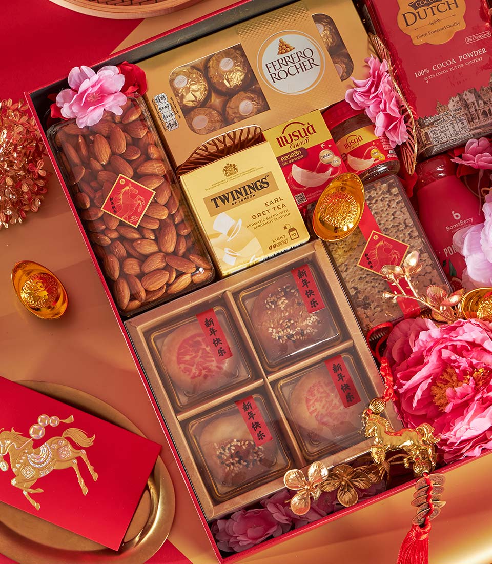 Luxury Chinese New Year gift box with Earl Grey tea, Ferrero Rocher, pastries, almonds, and festive gold accents