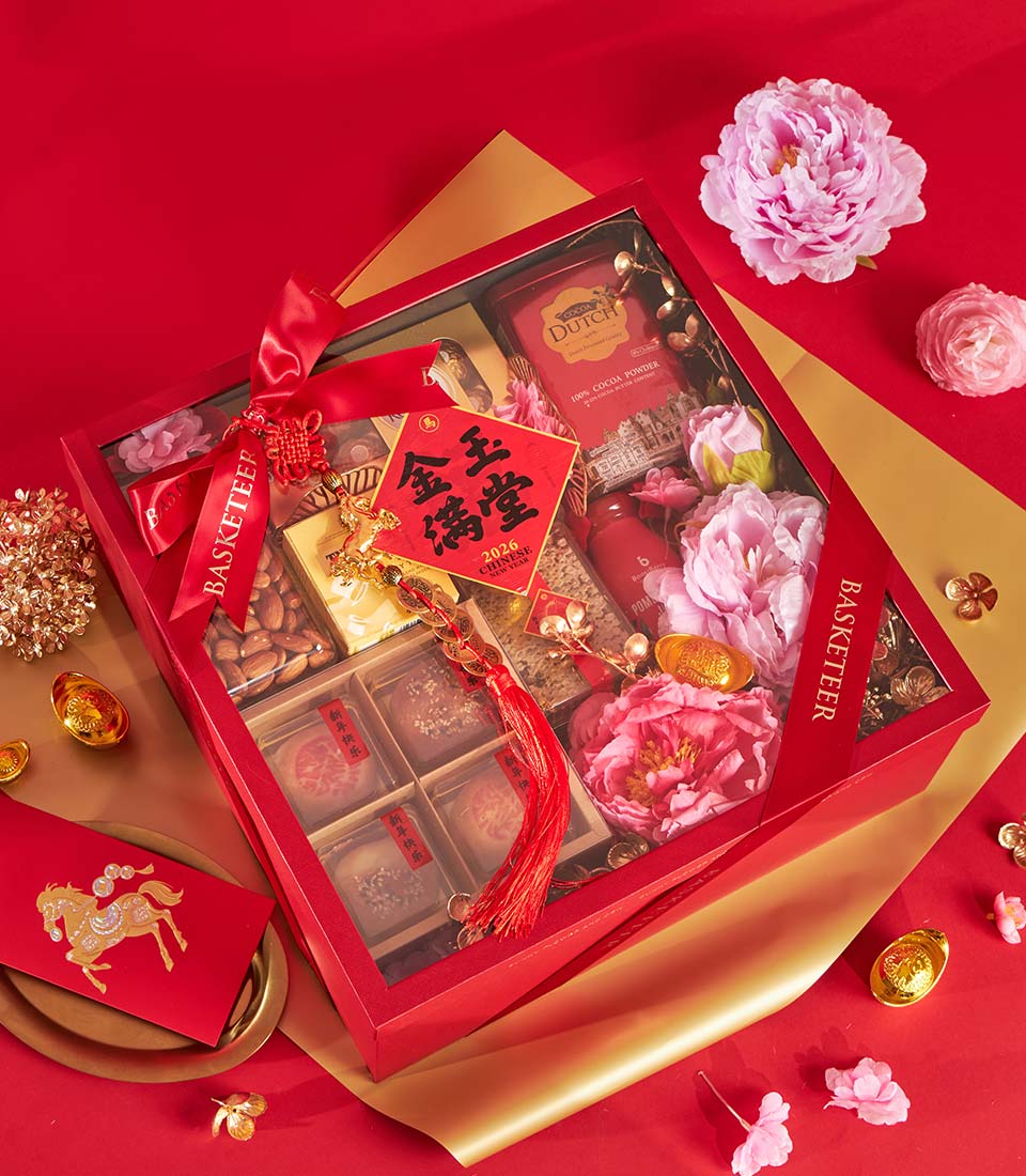 Luxury red gift box with premium tea, cocoa powder, almonds, and pastries for Chinese New Year celebration