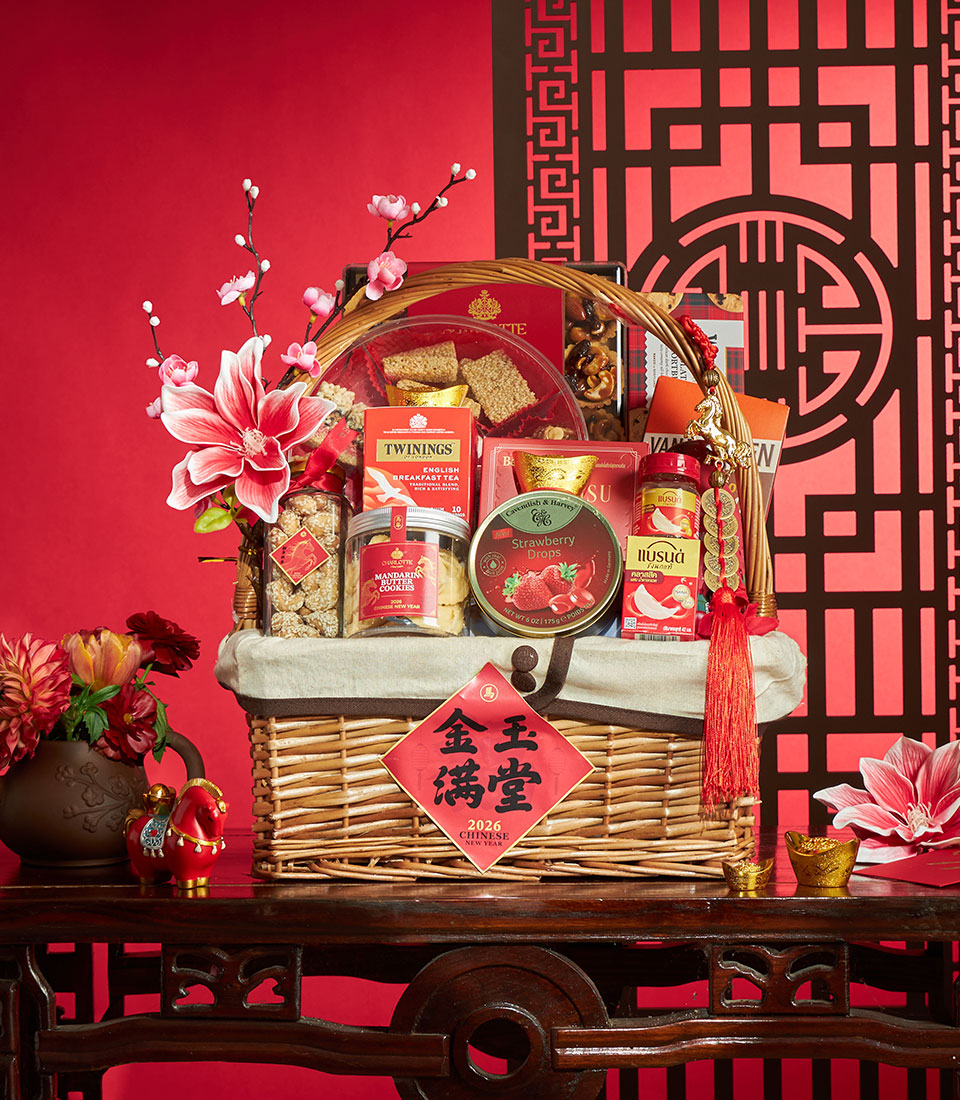 Luxury Chinese New Year gift basket with gourmet treats, tea, cookies, and golden accents on festive red backdrop