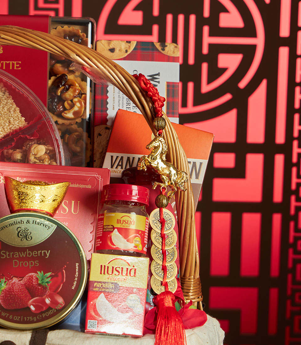 Luxury gourmet basket with strawberry candy, bird's nest, nuts and golden accents for Chinese New Year
