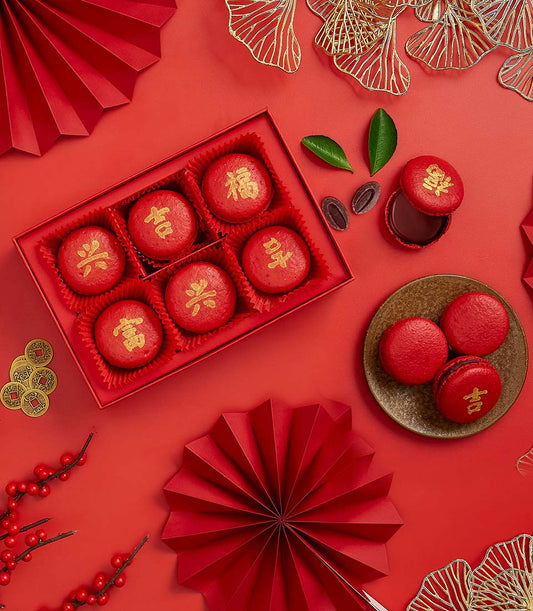Red macarons embossed with gold Chinese characters for fortune and prosperity, dark chocolate filling, Chinese New Year gift