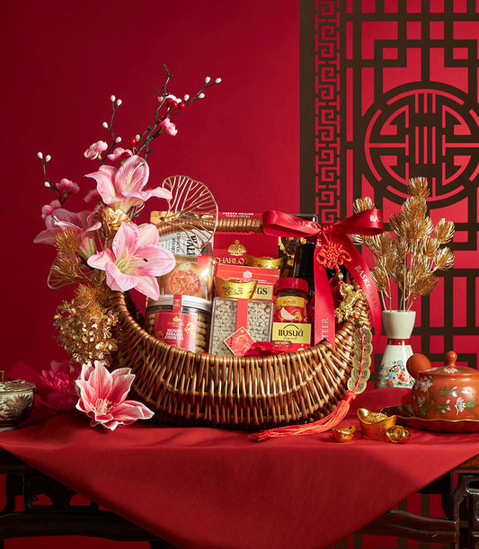 Premium Chinese New Year gourmet and wellness gift basket with wicker weave, gourmet treats, pink lilies, and gold festive