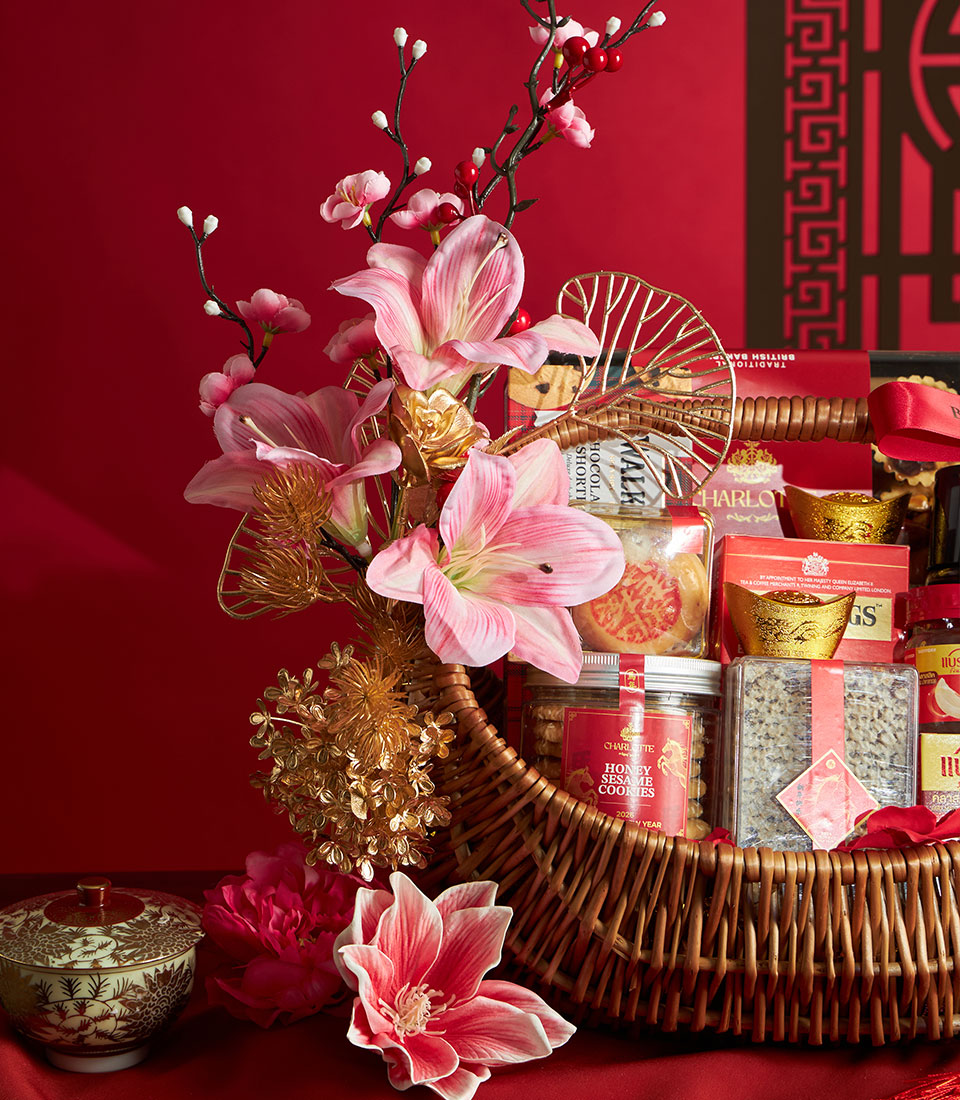 Luxury Chinese New Year gift basket with gourmet treats, honey cookies, and golden decorative accents on red background