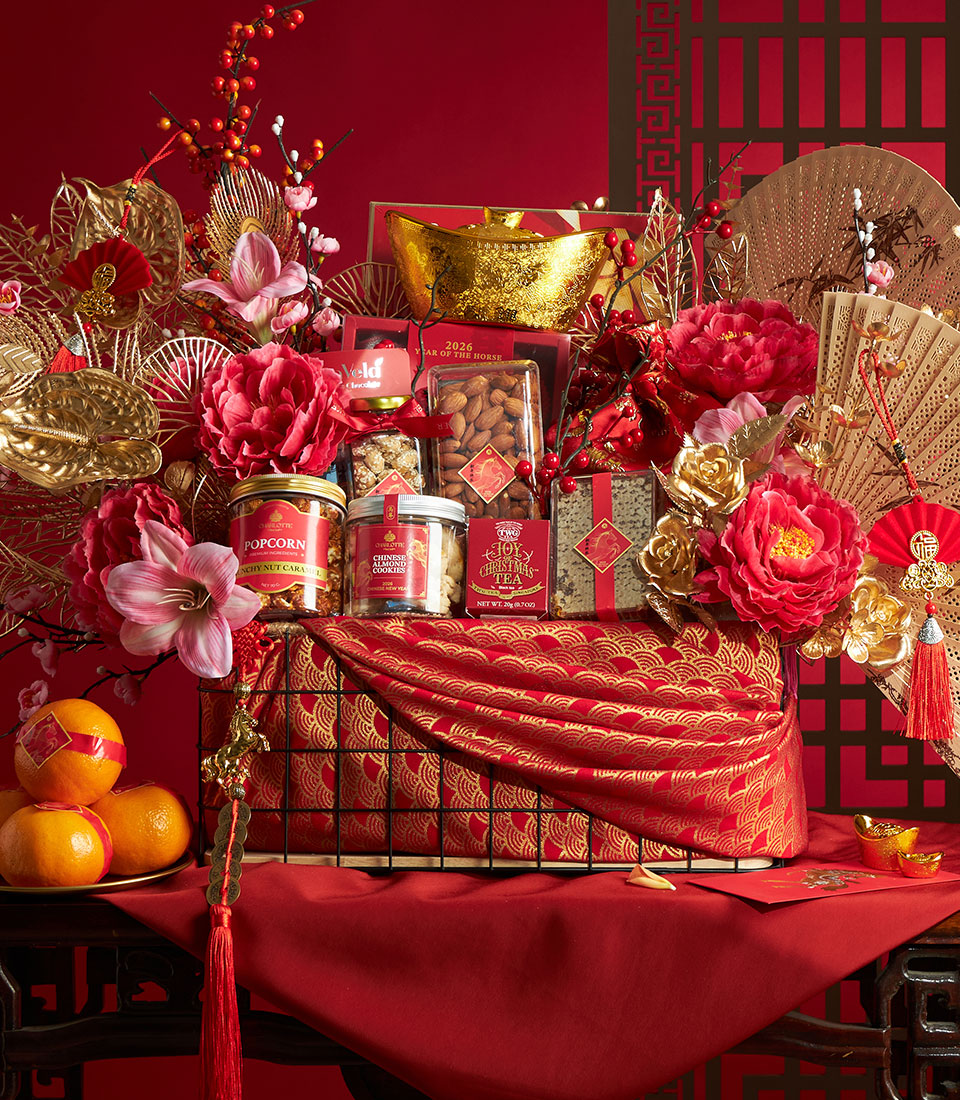 Luxury red and gold Chinese New Year gourmet gift hamper with caramel popcorn, almond cookies, tea, and festive decorations