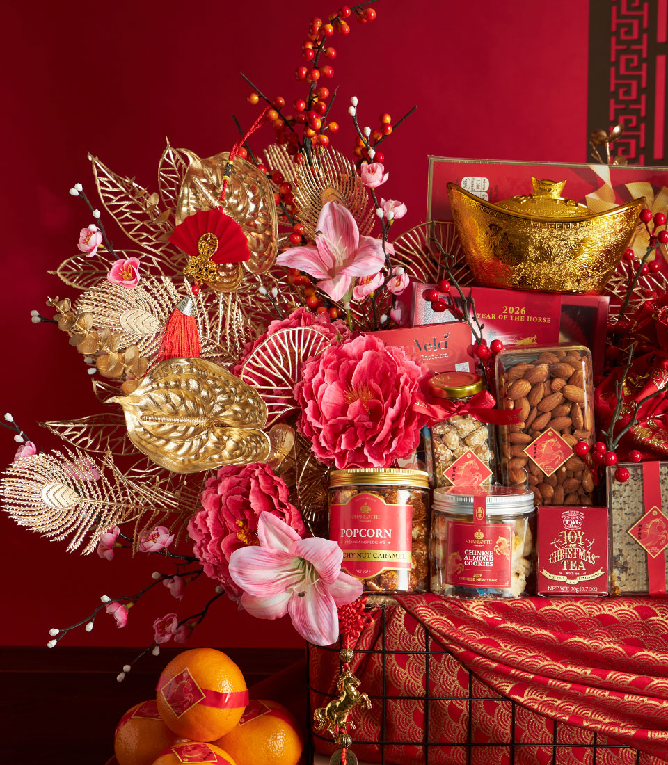 Luxury red and gold Chinese New Year gift hamper with gourmet treats, artisan chocolates, and festive decorations