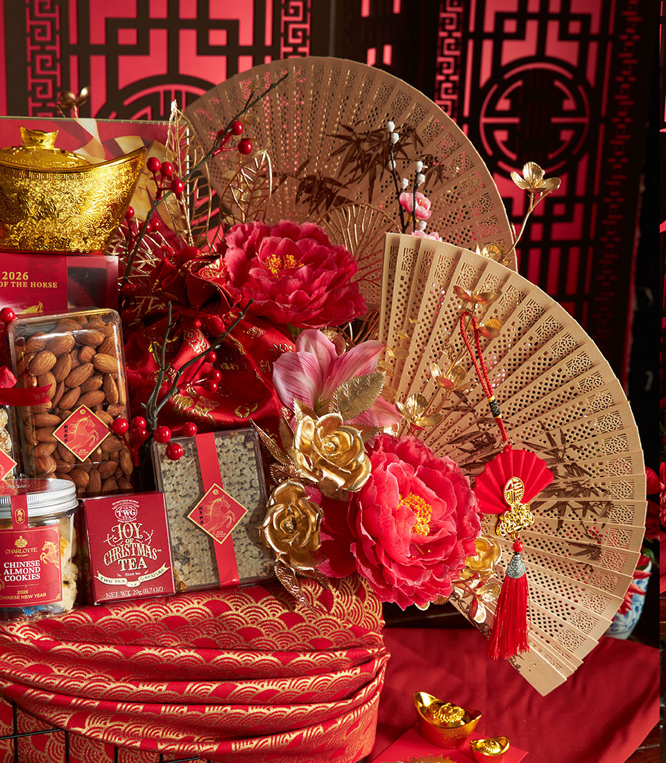 Luxury Chinese New Year gift hamper with gold decorative pot, almond cookies, premium tea, and red silk flowers on red