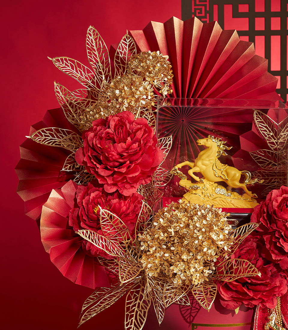 Basketeer: Luxurious Chinese New Year corporate gift featuring golden horse figurine, red fans, and vibrant floral arrangement. Premium hamper delivery Thailand.