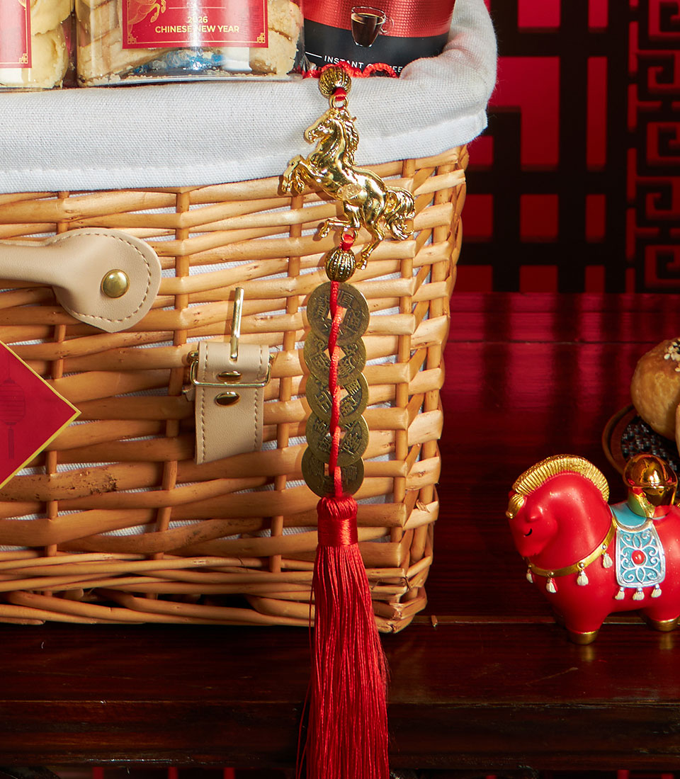 Premium wicker prosperity basket with gourmet treats, golden horse charm, and bronze coins for Chinese New Year gifting
