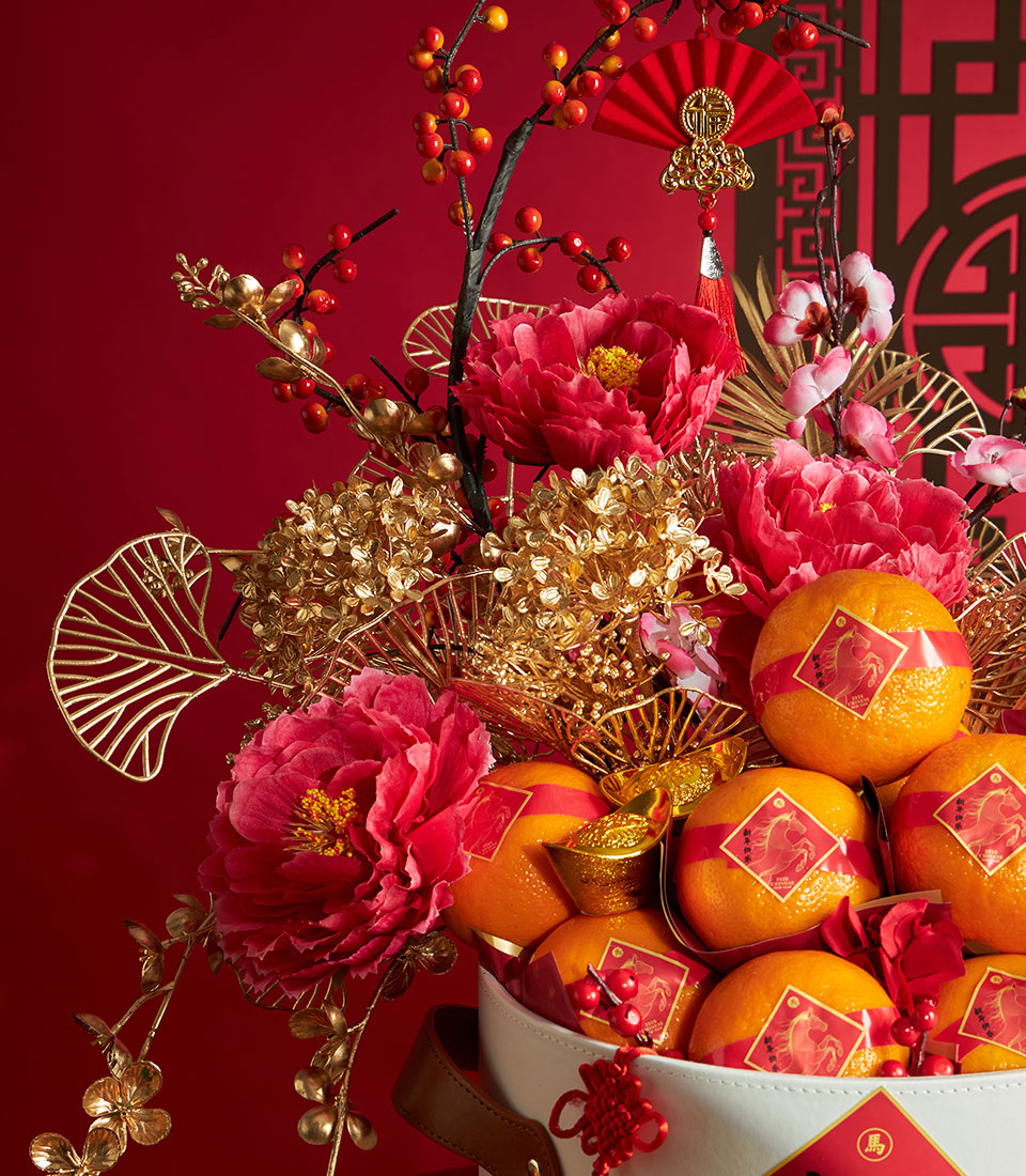 Luxury red and gold Chinese New Year mandarin orange basket with peonies, ginkgo leaves, and decorative fan charm