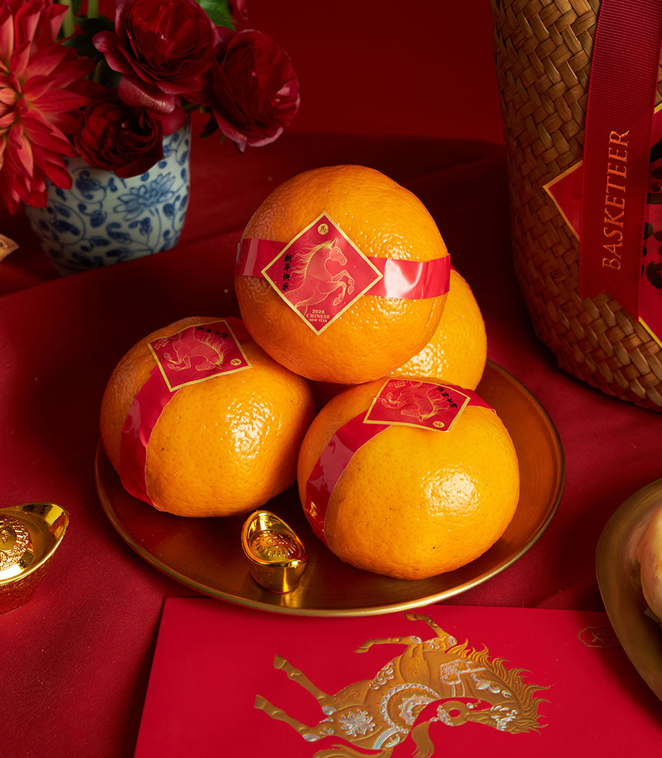Festive mandarin oranges with lucky gold ingots and red envelope in Chinese New Year gift hamper