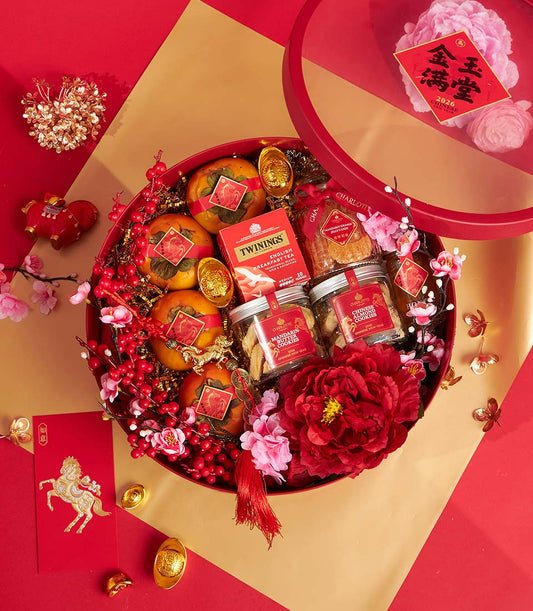 Festive red hamper with persimmons, Twinings tea, mandarin cookies, and gold coins for Chinese New Year