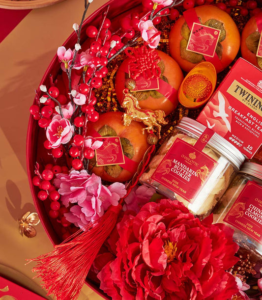 Festive red heart-shaped hamper with persimmons, premium tea, artisan cookies, and gold accents for Chinese New Year