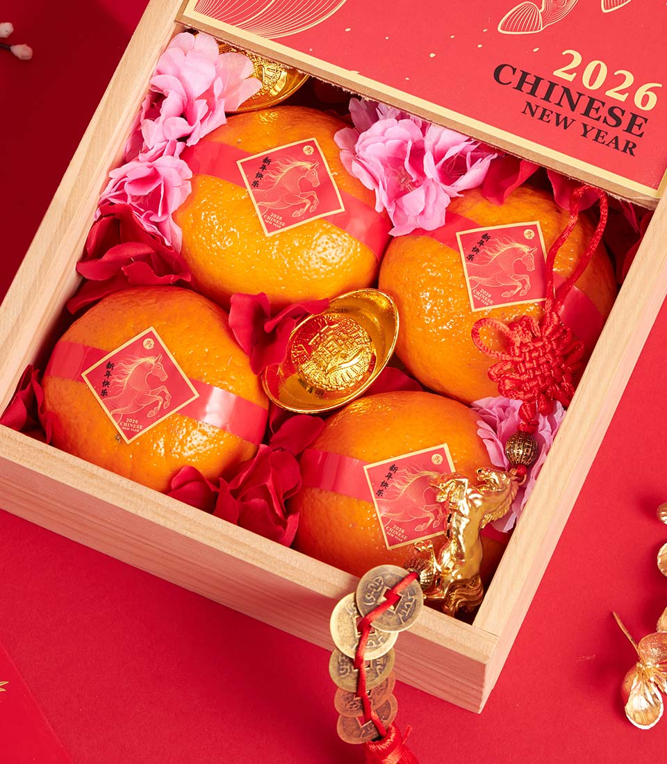 Premium mandarin orange gift box with golden horse wrapping, red silk tassels, and traditional Chinese New Year decorations