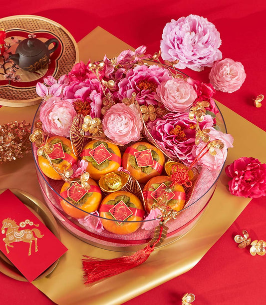 Festive Chinese New Year persimmon and mandarin fruit gift tray with golden horse design details, red envelope, and