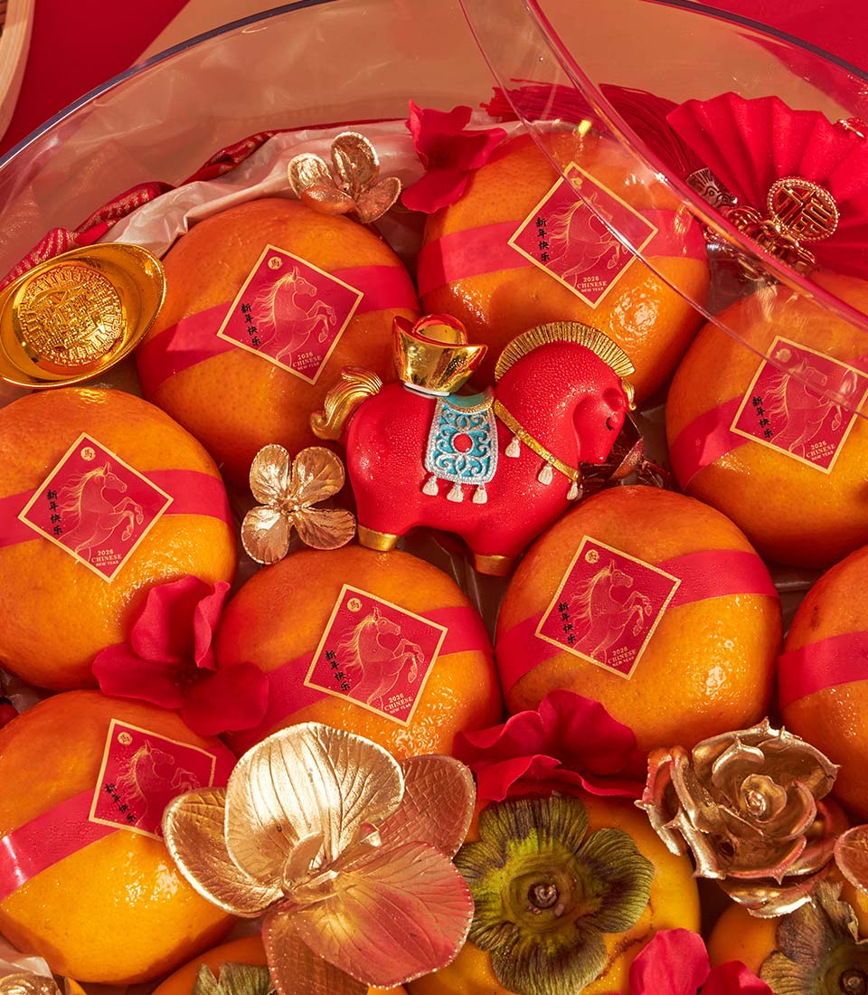 Premium Mandarin orange and persimmon gift tray with lucky horse figurine, golden ingots, and red silk ribbons for Chinese