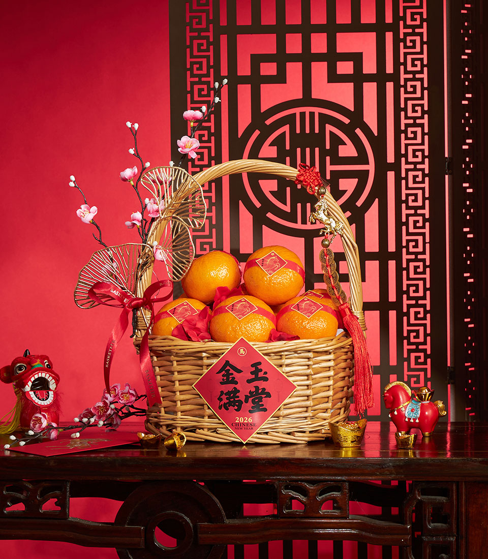 Basketeer's Chinese New Year gift: Mandarin oranges with festive accents in a woven basket. A premium hamper delivery in Thailand for prosperity.