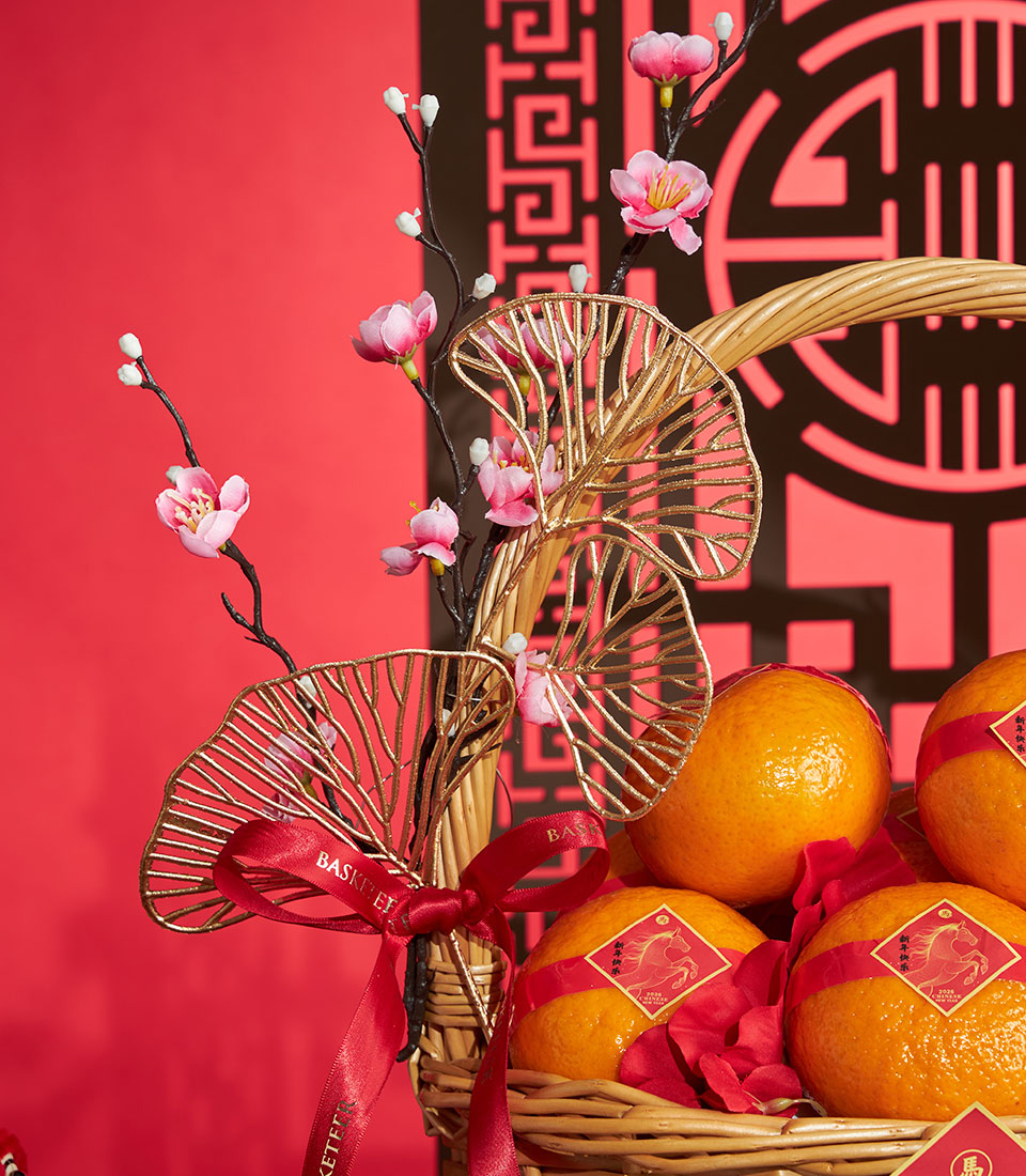 Prosperity Mandarin Orange Basket with red ribbons, cherry blossoms, and gold accents for Chinese New Year gifting