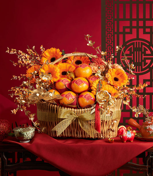 Festive wicker basket filled with mandarin oranges and golden flowers for Chinese New Year celebrations