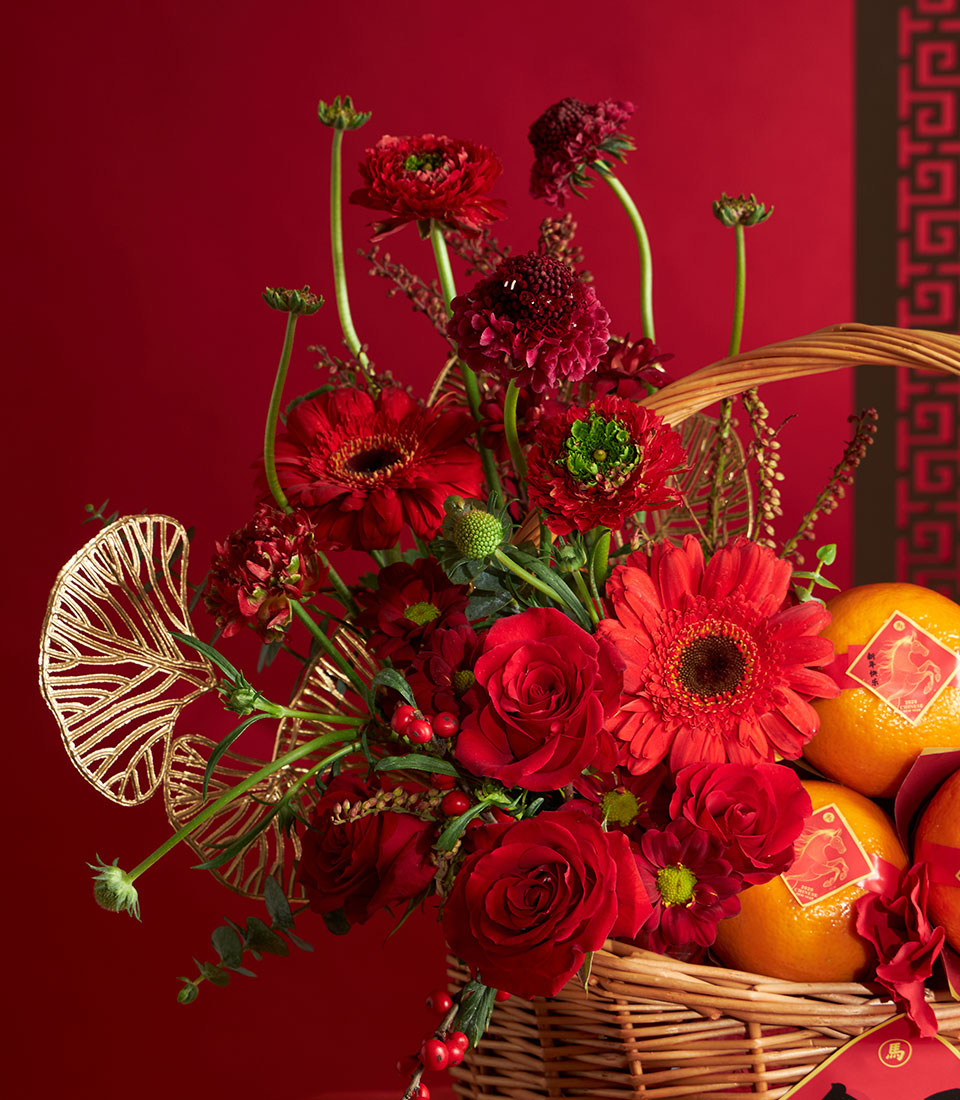 Festive red flower and mandarin orange wicker basket for Chinese New Year celebrations