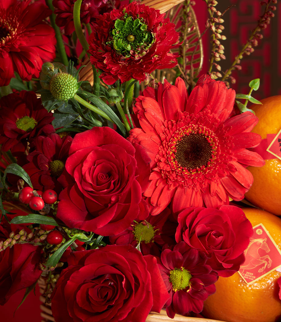 Chinese New Year mandarin orange gift basket with red roses, gerbera, and fresh flowers