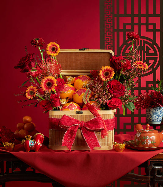 Festive red and orange flower arrangement with fresh mandarin oranges in bamboo box, Chinese New Year gift hamper