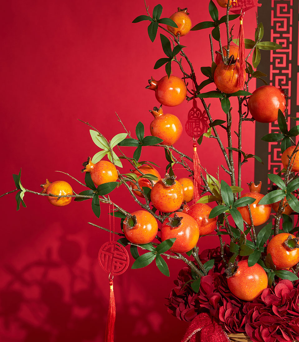 Basketeer Chinese New Year gift: Faux pomegranate branches and red hydrangeas arranged in a basket. A premium hamper for delivery in Thailand.