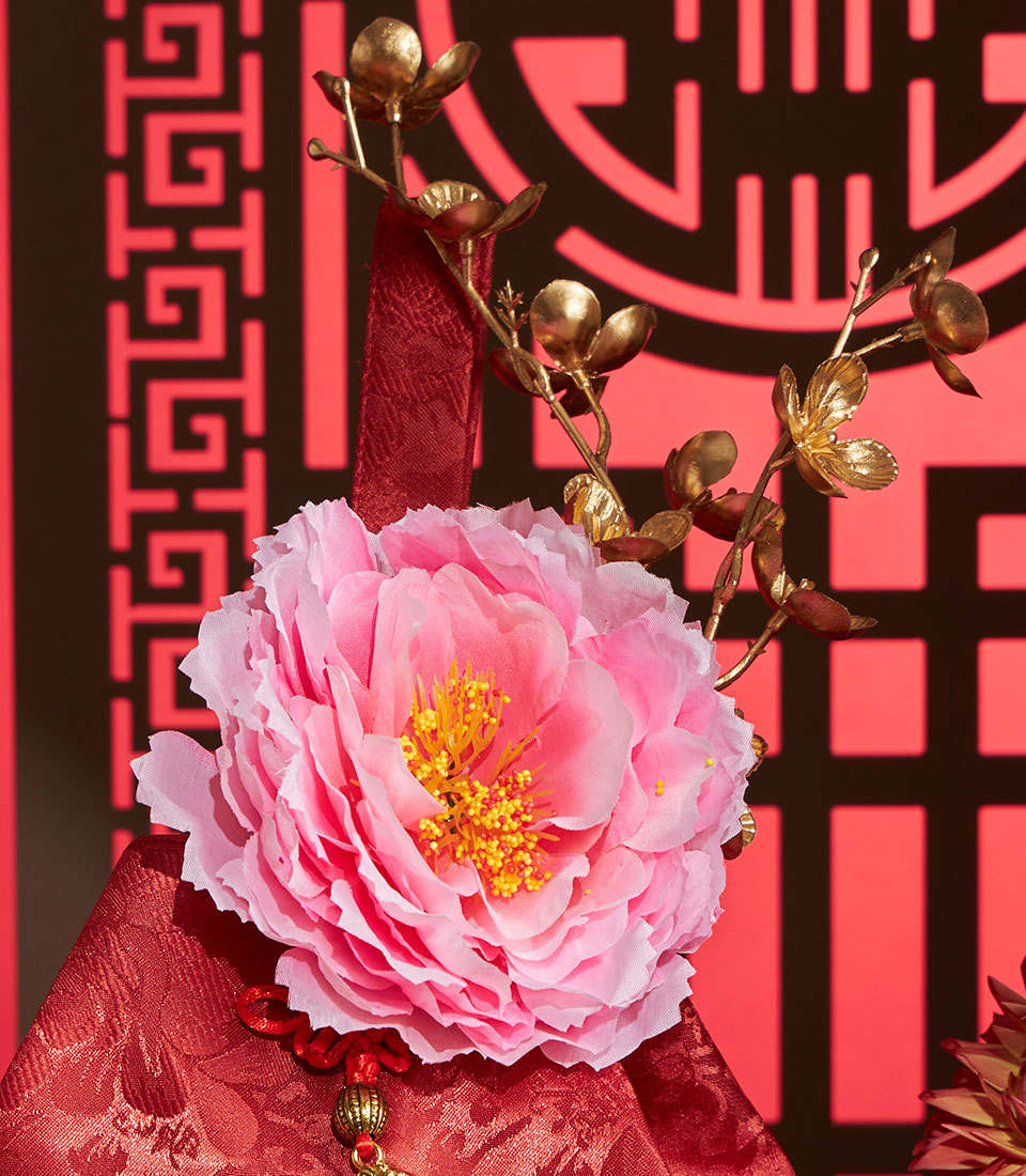 Vibrant pink peony with gold branches and red silk for Chinese New Year prosperity gift set