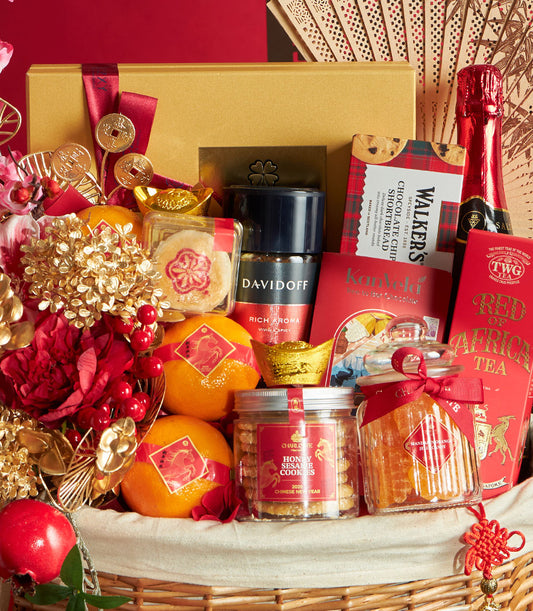 Red and gold Chinese New Year gift basket with mandarin oranges, gourmet cookies, premium coffee, and artisan tea