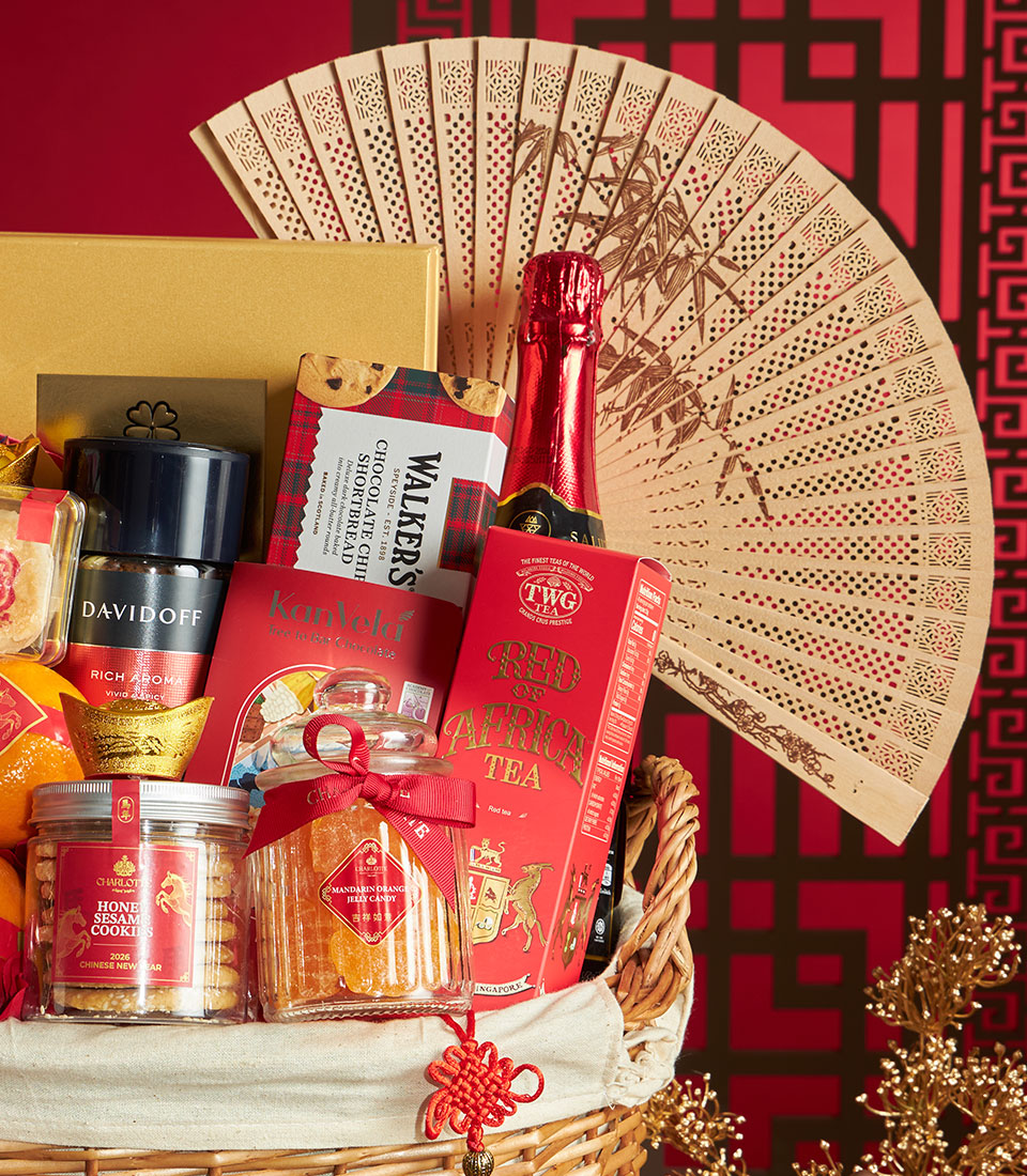 Festive red gift basket with mandarin oranges, gourmet tea, coffee, shortbread, and Chinese New Year charms