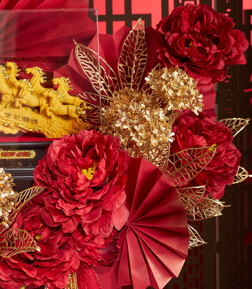 Basketeer's luxury gift for Chinese New Year: golden horses sculpture, vivid red peonies, and gold accents. A premium corporate gift for good fortune in Bangkok.