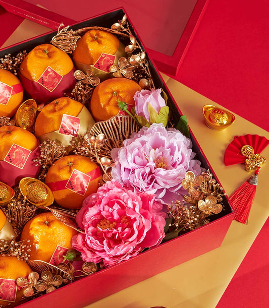 Luxury Chinese New Year gift box with Dekopon oranges, pink peonies, and gold decorative accents