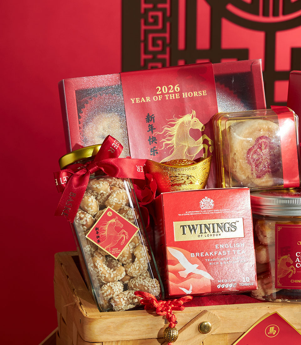 Festive Chinese New Year gourmet gift basket with premium treats, gold horse box, sesame snacks, and English breakfast tea