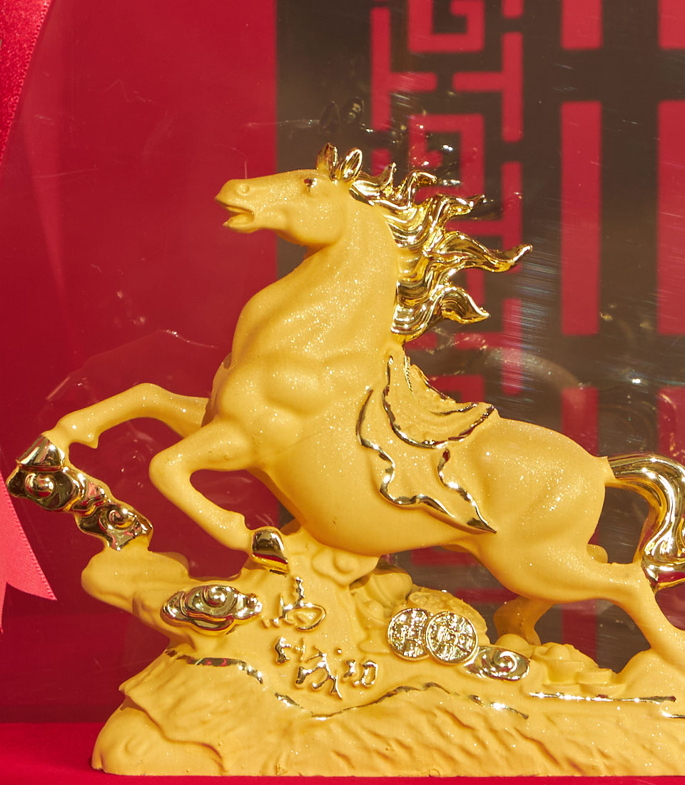 Golden rearing horse sculpture with glittery finish, lucky coins and cloud motifs, Chinese New Year gift