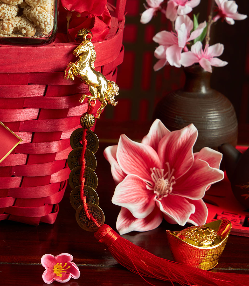 Premium Chinese New Year gift basket with sesame snacks, golden charm, and festive decor accents