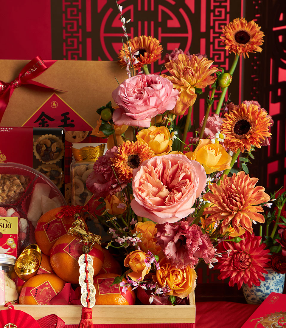 Luxury mandarin orange and gourmet gift basket with gold ingots, festive red packaging, and premium snacks for Chinese New