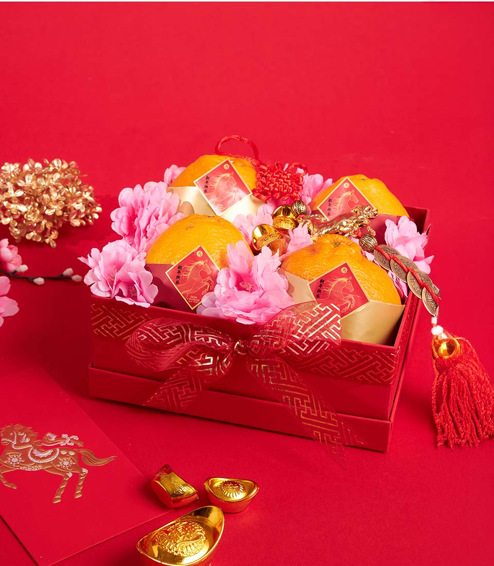 Premium Dekopon orange gift box with pink flowers, red ribbon, and gold accents for Chinese New Year celebrations