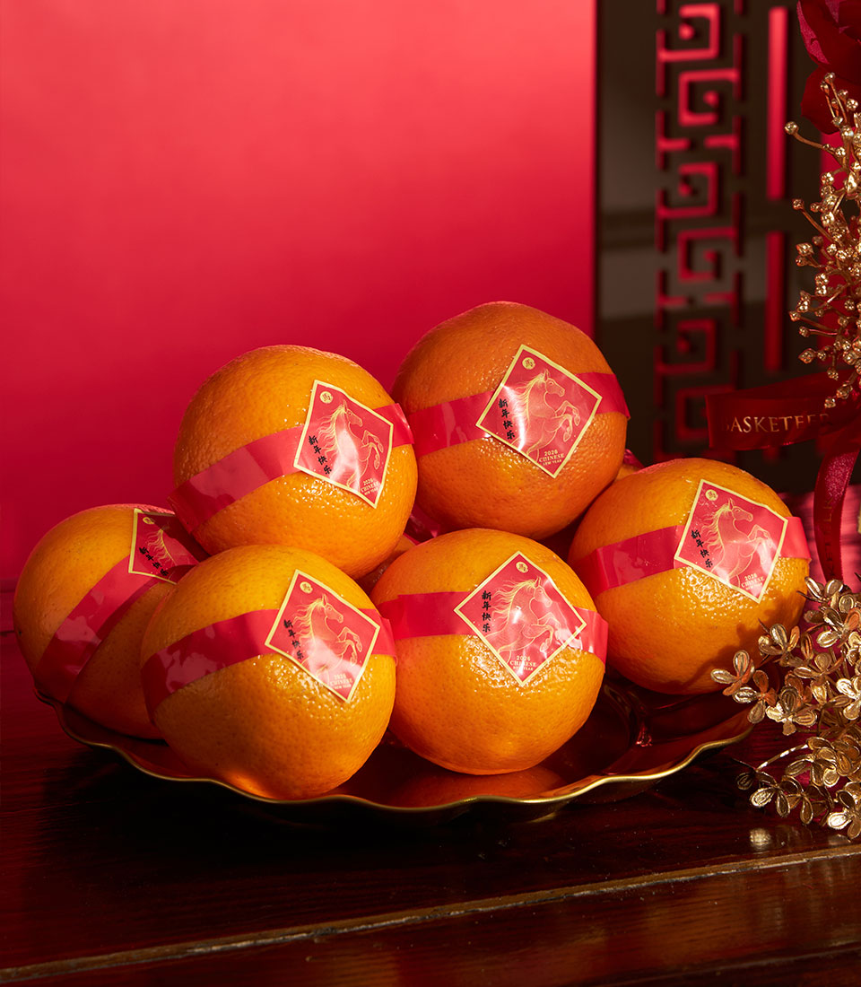 Mandarin oranges with golden horse labels on scalloped gold tray, Chinese New Year gift hamper